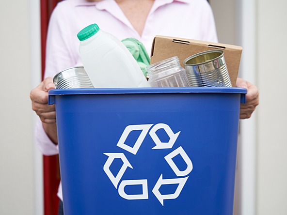 person holding recycling bin